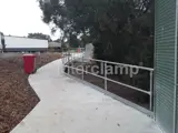 DDA disability handrail on concrete footpath